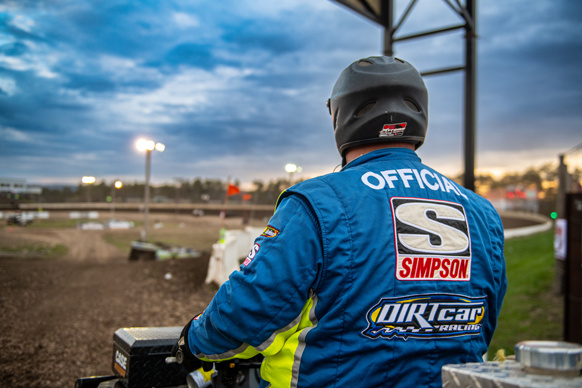 A saftey Official sits perched on an ATV watching the track waiting for anything that might happen. 